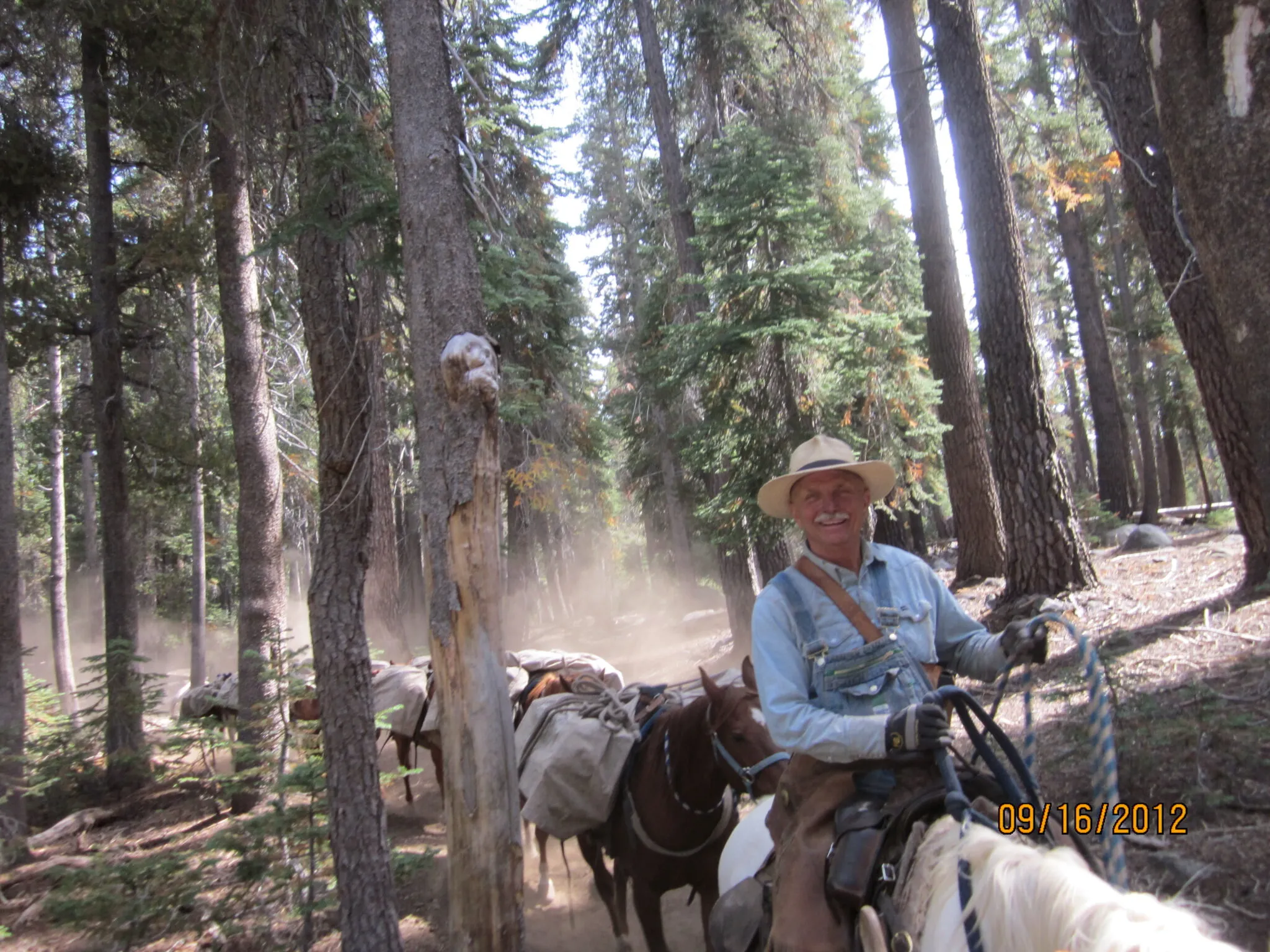 antique photo of people pushing a car up a steep hill