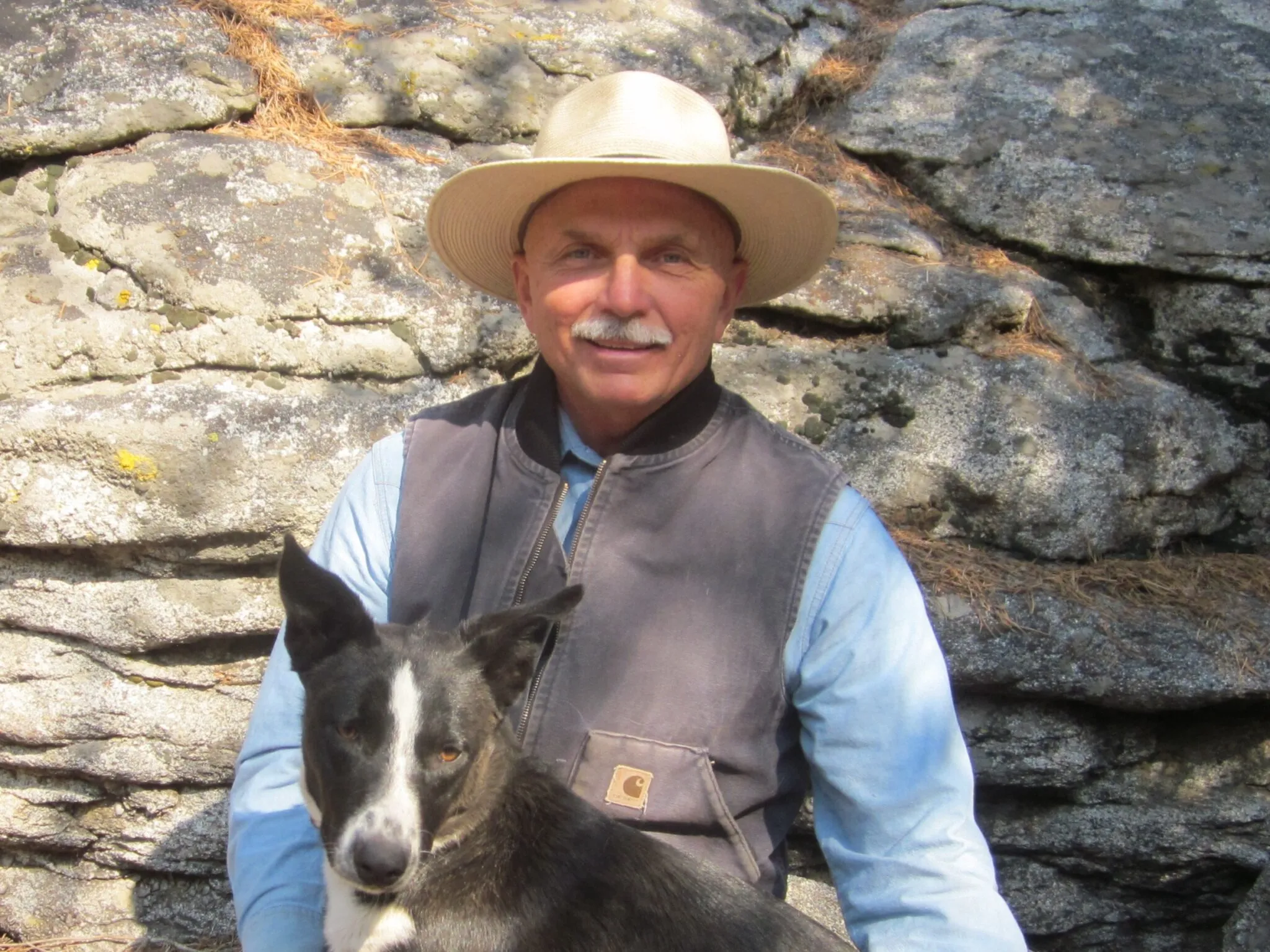 antique photo of people pushing a car up a steep hill