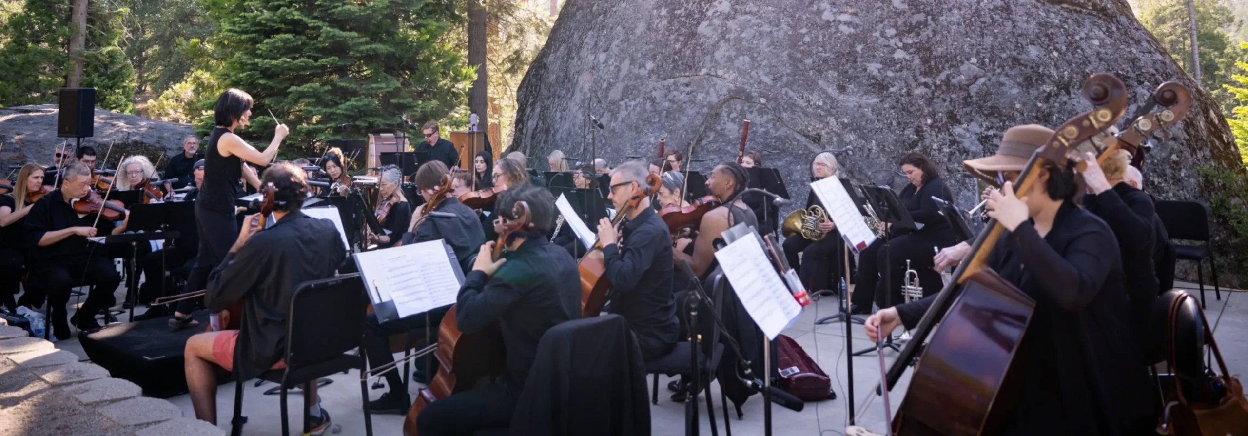 an orchestra performing at the museum amphitheater
